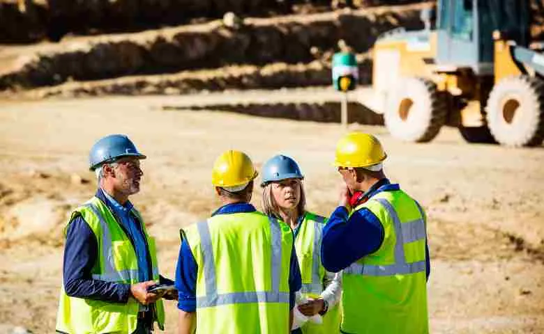 Construction workers ready for relocation in front of a moving truck