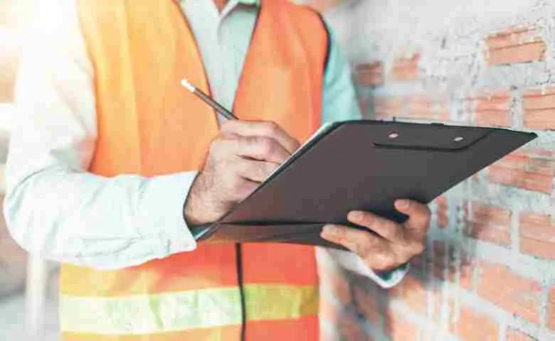 Engineer examining off-site construction blueprints.