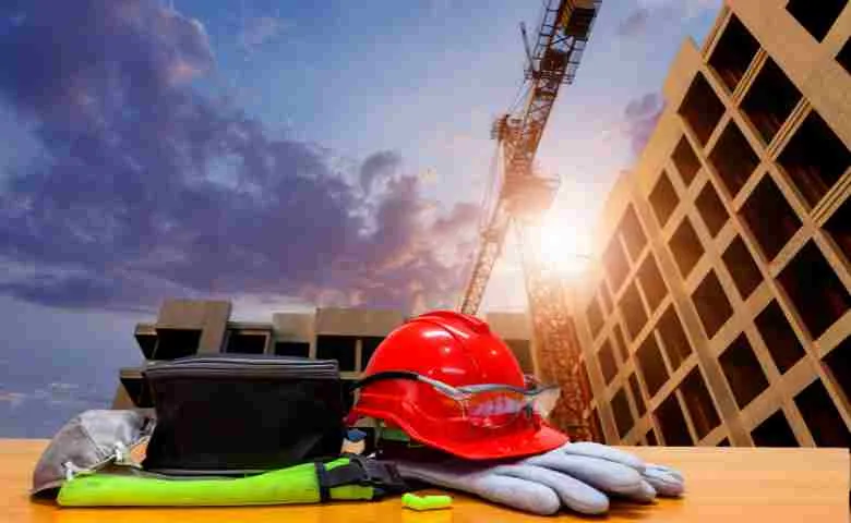 Blueprints and hard hat representing the start of a construction company.