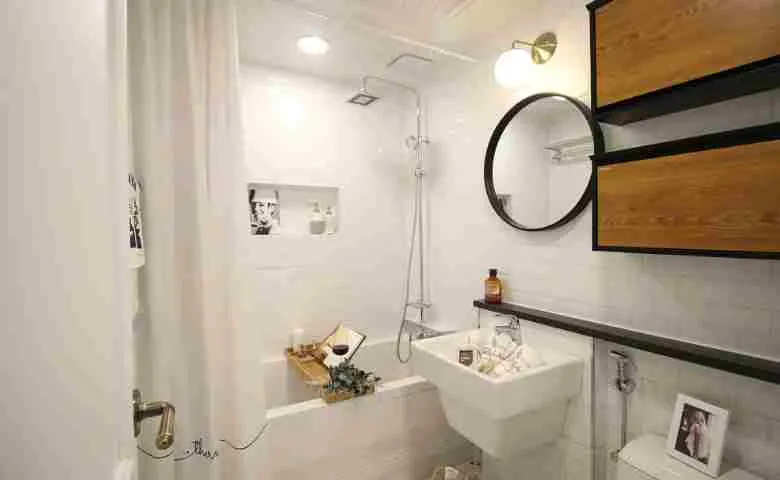Modern bathtub with an overhead shower and stylish accessories
