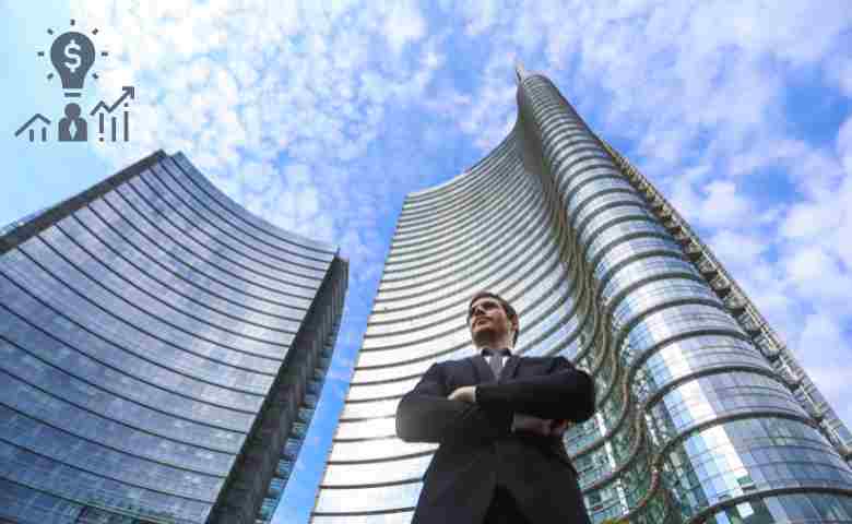 a Successful Construction Entrepreneur standing Infront of newly constructed building project.