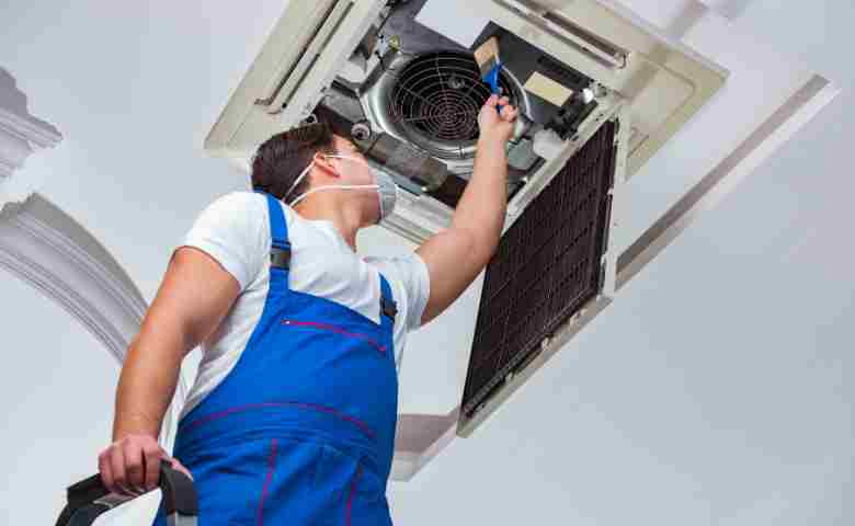 Professional HVAC technician servicing an air conditioning unit