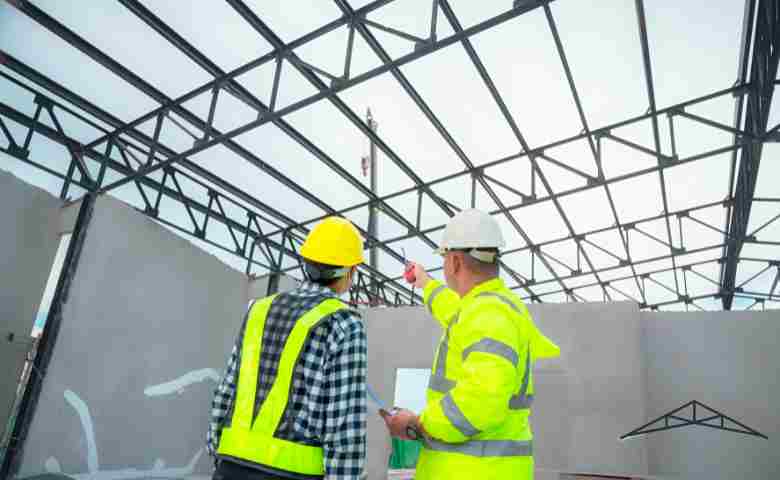 A structural engineers reviewing the construction site of structural elements