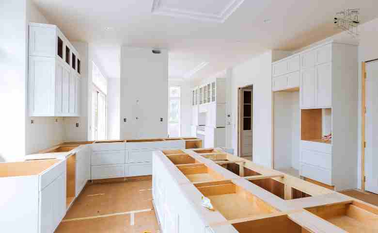 A compact, modern kitchen featuring smart storage solutions, a foldable dining table, and sleek, space-saving designs.