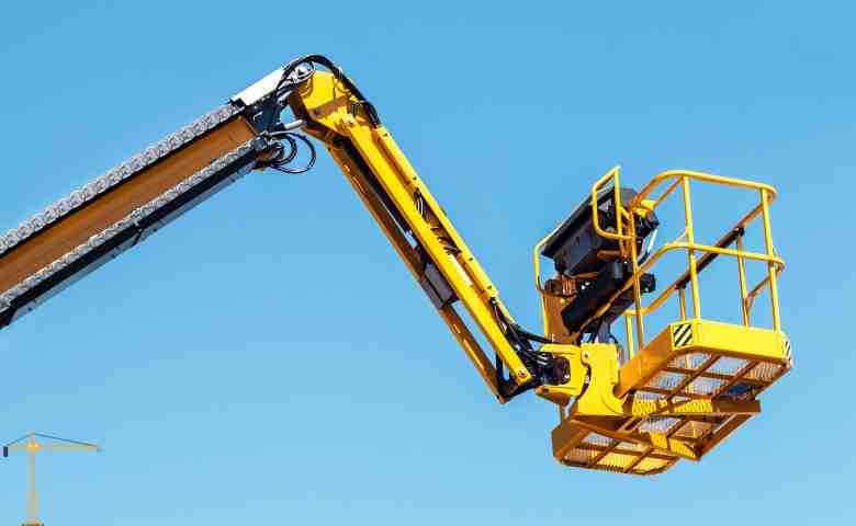 Construction workers using advanced lift equipment on a high-rise project.
