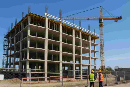 construction site with partially completed structure under blue sky