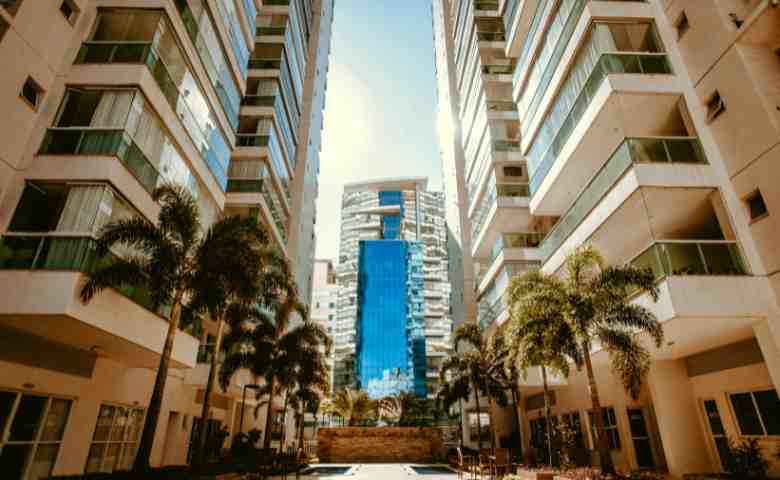 Modern high-rise condo living room after space-saving remodeling with open-plan design and panoramic city views.